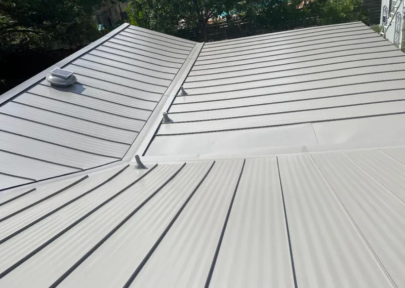 Solar attic fan installed on a metal roof for Roof Ventilation in Highland Park